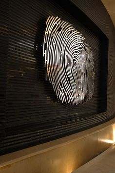 a close up of a fingerprint on a wall in a building with lights around it