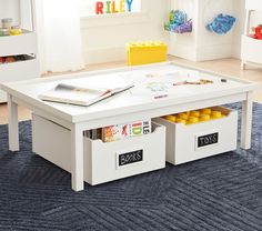 a child's play table with two storage bins