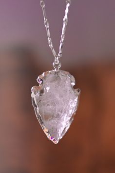 Like wearing a crystal ball at your heart, this ethereal Quartz arrowhead necklace is one of those pieces you can wear casually over a graphic tee or on top of a black dress! Quartz is the Stone of Clarity, helping you channel the energy of your Vision and hold true to that path. Pair this with our I Am Crystal Clear Quartz Arrowhead Earrings. Quartz gemstone arrowhead pendant with silver edge detailing Sterling silver cable, bar or satellite chain (refer to listing image) Handmade in Arizona Mo Arrowhead Earrings, Crystal Quartz Necklace, Arrowhead Pendant, Arrowhead Necklace, Mala Necklace, Silver Bars, Quartz Necklace, Necklace Sizes, Crystal Ball