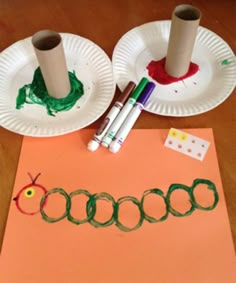 two paper plates and some crayons on a table