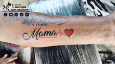 a person with a tattoo on their arm that says mama and has two hearts in it