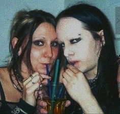 two women pose for the camera with their drinks