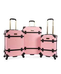 three pieces of pink luggage sitting next to each other with black handles and straps on wheels