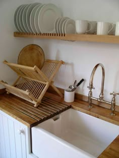 the kitchen sink is clean and ready to be used for dishes, cups, and utensils