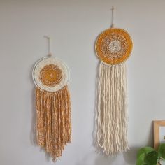 two wall hangings made out of yarn and rope with circular designs on the sides