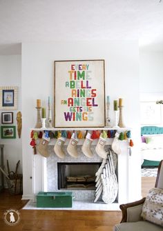 a living room filled with furniture and a fire place covered in christmas stocking next to a fireplace