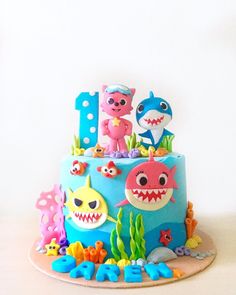 a birthday cake decorated to look like an ocean theme with shark, corals and other sea creatures