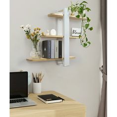 a laptop computer sitting on top of a wooden desk next to a shelf filled with books