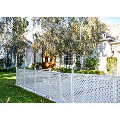 a white picket fence in front of a house