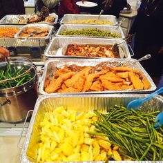 many trays of food are lined up on the table