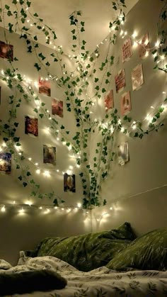 a bedroom with lights strung from the ceiling and ivy growing on the wall above the bed