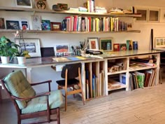 a room with bookshelves filled with lots of books and chairs next to each other