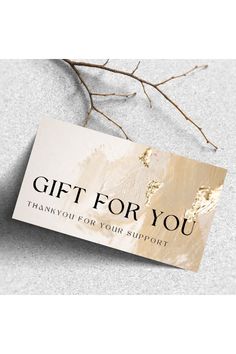 a gift card sitting on top of a table next to a tree branch with the words, gift for you thank you for your support