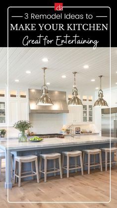 the kitchen island is surrounded by stools and lights