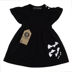 This adorable little black dress is the perfect addition to any little girl's wardrobe. Made from soft and comfortable cotton, it features a playful bat print at the hem that's sure to delight.  With short sleeves and a convenient popper fastening at the shoulder, it's easy to put on and take off, making it a great choice for busy mornings. And the best part? This dress isn't just for Halloween - it's versatile enough to be worn year-round, for any occasion. Dress it up with a pair of cute shoes Alternative Baby Clothes, Goth Baby Clothes, Gothic Baby, Girls Cotton Dresses, Baby Girls Dresses, Goth Baby, Baby Bats, Basic Dress, Baby Outfits