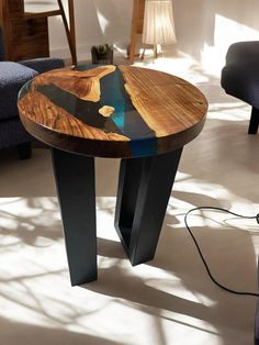 a wooden table sitting on top of a hard wood floor next to a chair and lamp