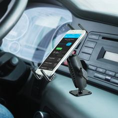 a cell phone is attached to the dashboard of a car while holding an air vent