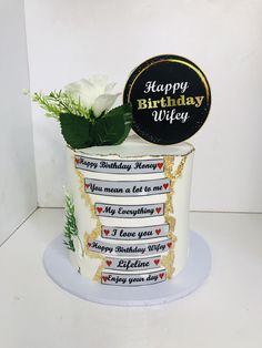 a birthday cake with white flowers in it