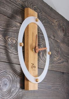 a clock made out of wood and glass on a wooden wall with the word time