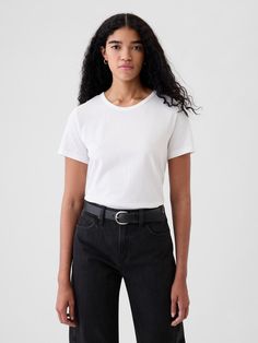 Made with 100% organically grown cotton.  Organic cotton is better for people and the environment because it’s grown without the use of harmful synthetic pesticides and fertilizers.  Short sleeves.  Crewneck.  Straight silhouette with a relaxed fit.  Hits at the hip.  Chloe is 5'8. 5/174cm with a 32"/81cm chest, 25"/64 cm waist and a 35"/89cm hip wearing a regular Gap White Pants Outfit, White Crew Neck, Vintage Crewneck, Clothing Design, Pesticides, White Pants, Pima Cotton, Pants Outfit, Classic White