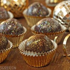 there are many different types of chocolates on the table with gold foil around them