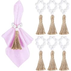 six tassels with white beads and a pink bow tie on the side, one is