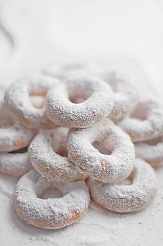 a pile of powdered donuts sitting on top of a table