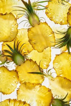 pineapple slices are arranged on a white surface