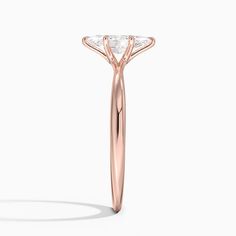 a rose gold ring with three diamonds on it