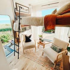 a bedroom with a bunk bed and chairs in it