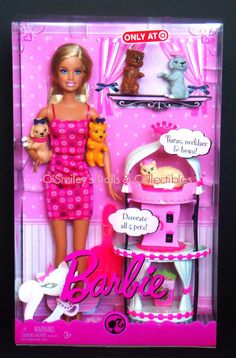 the barbie doll is in her pink dress and has three cats on it's back