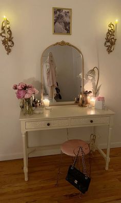 a dressing table with flowers and candles on it