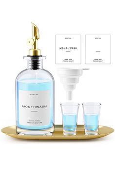 a bottle of mouthwash and two glasses on a tray