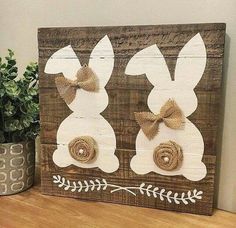 a wooden sign with two bunnies on it