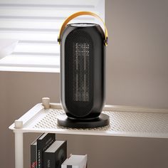 an air purifier sitting on top of a shelf next to some books