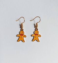 Enamel christmas gingerbread earrings on gold plated earring hooks. Hooks are nickel & lead free. Each pair of earrings are handmade to order, come inside a sealed cellophane packet and on an earring backing card. All jewellery items ordered are sent in protective bubble lined padded envelopes. Thank you for supporting our small business.  PLEASE NOTE  All our items come with free delivery as standard, and aims to be with you within 2-3 days. There is also the option to upgrade to 1st class delivery at the checkout for a fee of £1.29 and aims to be with you within 1-2 days.  We are offering a standard international postage delivery fee of £4.20 from royal mail. This aims to deliver your order to europe within 5 business days, and the rest of the world within 7 business days.  There is also Gingerbread Earrings, Enamel Jewellery, Christmas Jewellery, Jewellery Gold, Backing Card, Christmas Earrings, Christmas Gingerbread, Earring Hooks, Enamel Jewelry