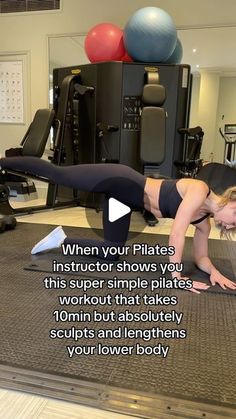 a woman is doing push ups on the floor in front of a gym equipment machine