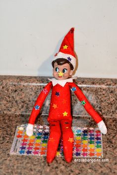 an elf doll sitting on top of a counter