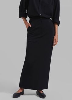 Color: Black Midweight woven fabric Relaxed fit Maxi length Slant hip pockets Illusion welt back pockets Back slit Zip fly Hook and bar closure Partially lined 61% Polyester 33% Rayon 6% Elastane Dry Clean By The Frankie Shop. Imported Black Full-length Maxi Skirt For Work, Black A-line Maxi Skirt For Winter, Closet Minimal, Skirt With Black Tights, Long Black Pencil Skirt, Luxury Sleek Black Maxi Skirt, Black A-line Voluminous Maxi Skirt, Maxi Pencil Skirt, Luxury Black A-line Maxi Skirt