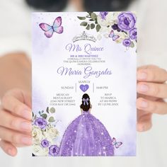 a woman holding up a purple and white wedding card with flowers on the front, and butterflies on the back