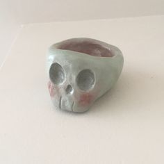 a skull shaped vase sitting on top of a table