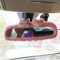 two pink hello kitty car mirrors with the words love written on one side and an i love you sign on the other