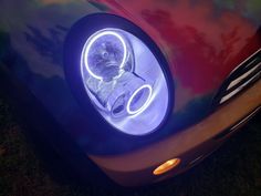 a close up of a car headlight with the lights on