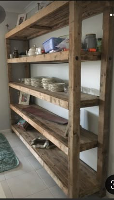 the shelves are made out of wood and have plates on them