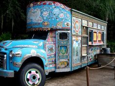 an old blue food truck is parked in the dirt