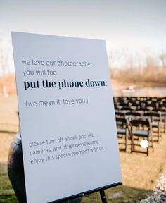 a sign in front of rows of chairs that say we love our photographer, you will too put the phone down