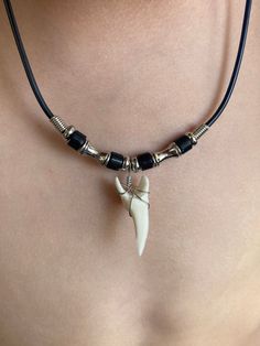 Necklace Length:  Approx. 18 inches Shark Tooth Length: Approx. 1-1/8 inch Each piece has a distinct character of its own, for no two are exactly alike in color, shape, and size. Hand-crafted, sanded and polished by Native artisans Adjustable Black Themed Necklace, Themed Black Beaded Jewelry, Hawaiian Design, Mako Shark, Moda Hippie, Hawaiian Designs, Shark Tooth Necklace, Surfer Necklace, Tooth Necklace