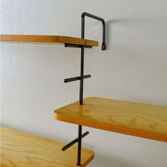 two wooden shelves with metal brackets on them