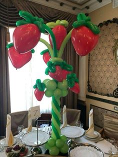 the table is set with plates, silverware and fruit inflatable to look like strawberries