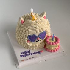 a birthday cake with a cat on top